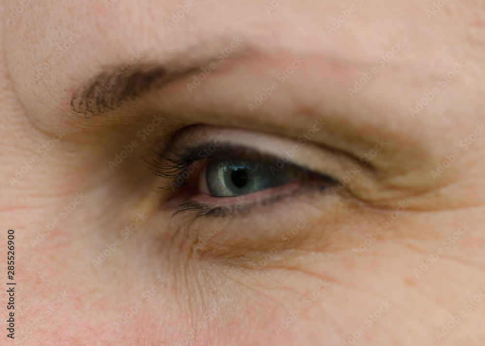 Obraz premium Woman face with blue eye in detail