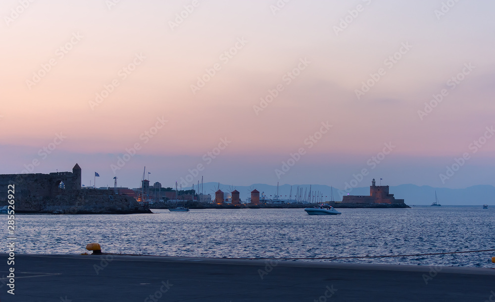 Agios Nikolaos fortress on the Mandraki harbour of Rhodes Greece. Sunset