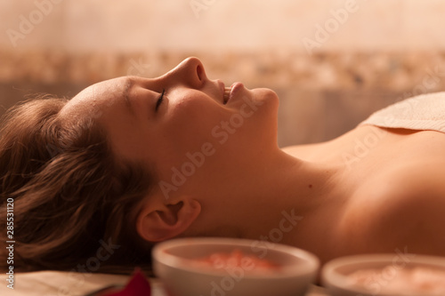Beautiful woman receiving a massage in a spa.