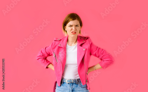 Ew. Ick, yuck. Woman on pink background looking at the camera and feeling disgusted. 