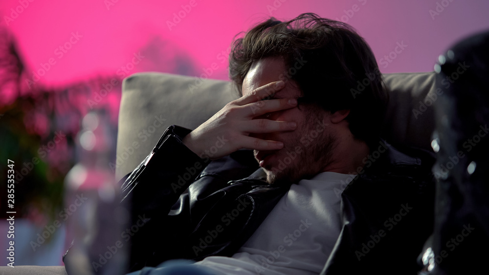 Booze feeling unwell at rave party in night club, alcohol and drugs intoxication Booze feeling unwell at rave party in night club, alcohol and drugs intoxication