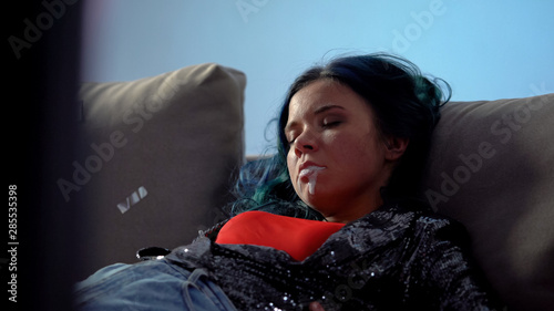 Rave drug overdose, unconscious junkie girl mouth foaming at home after party