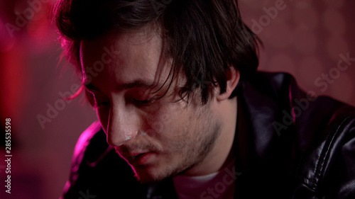 Guy with heroin on nose relaxing at party, drug addict needs help, awareness