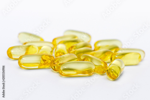 vitamin pills or gel capsules on white background