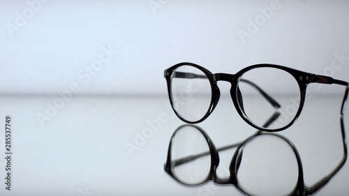 Classic eyeglasses with diopters on table in ophthalmologist office, diagnostics