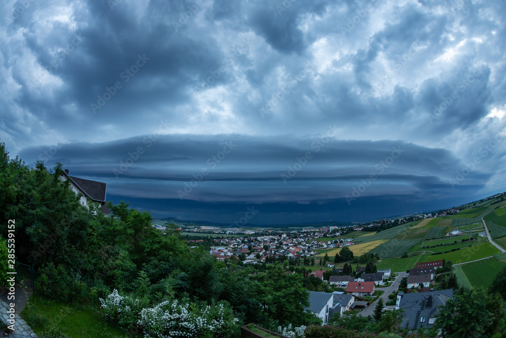 Approaching supercell with shelf cloud. Photographed with fisheye lens, otherwise it would not fit in the frame