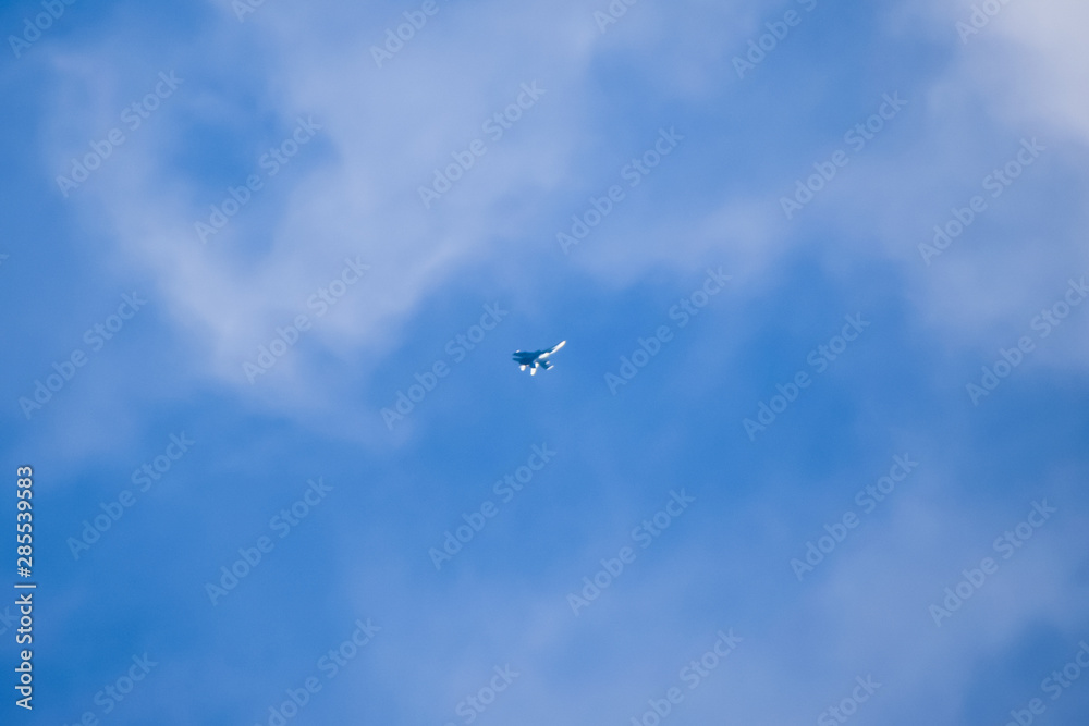 The fighter in the blue sky. Flying an airplane
