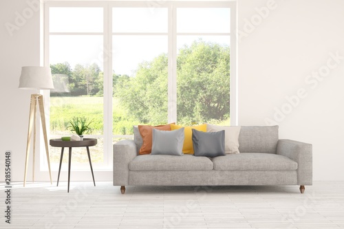 Stylish room in white color with sofa and summer landscape in window. Scandinavian interior design. 3D illustration