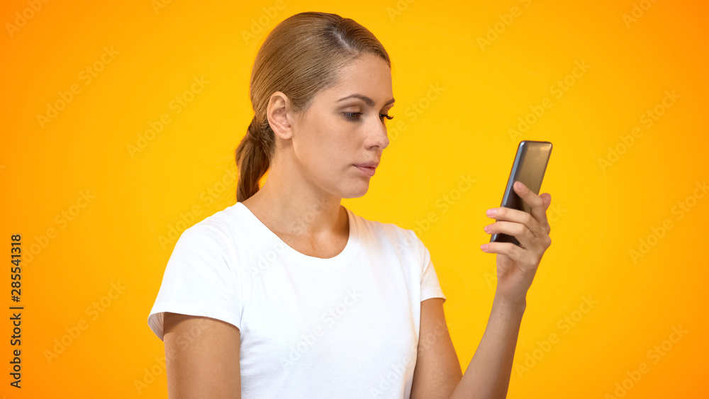 Young woman reading smartphone message, social networks app, internet connection Young woman reading smartphone message, social networks app, internet connection