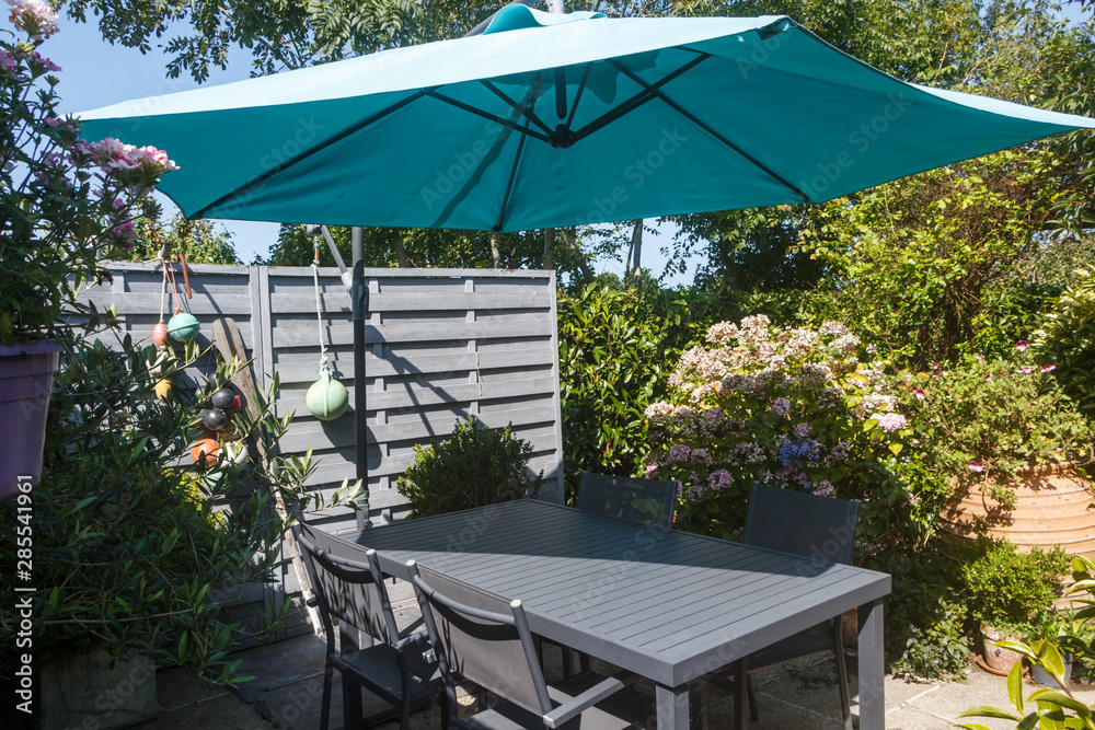 Flowered terrace with garden furniture during summer