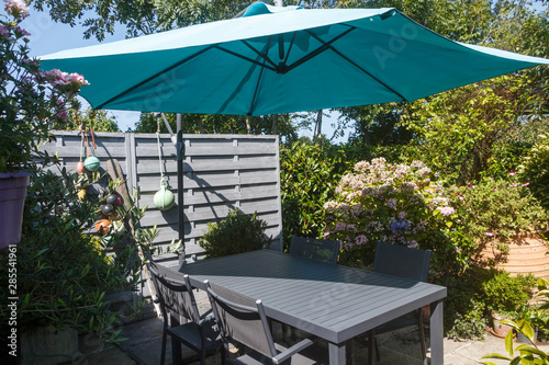 Flowered terrace with garden furniture during summer