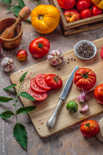 Tomatoes on cutting board with knife