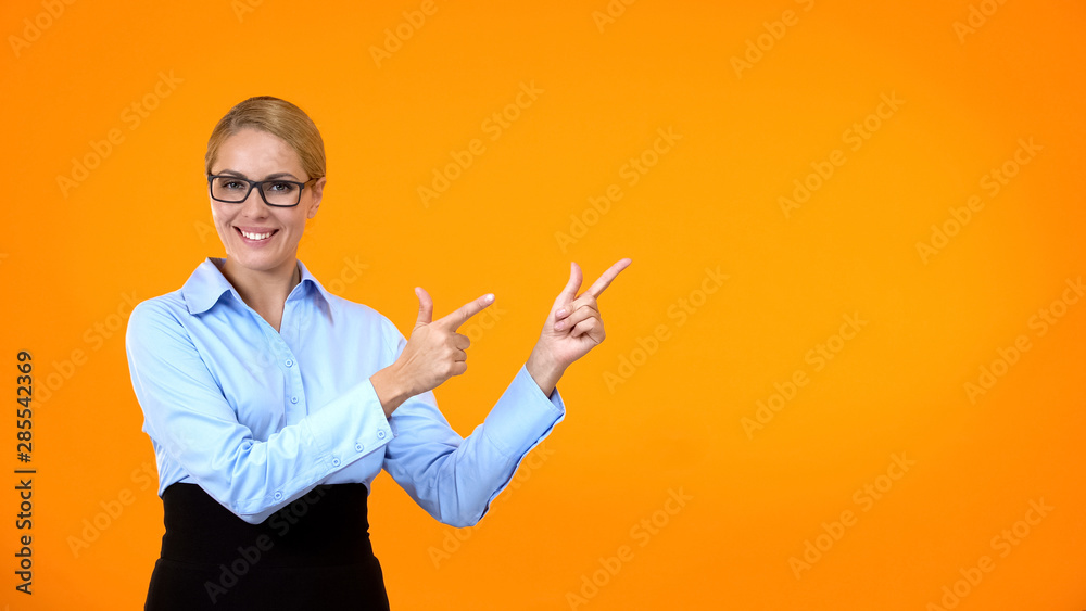 Pretty woman showing template pointing by fingers, business suggestion, offer Pretty woman showing template pointing by fingers, business suggestion, offer