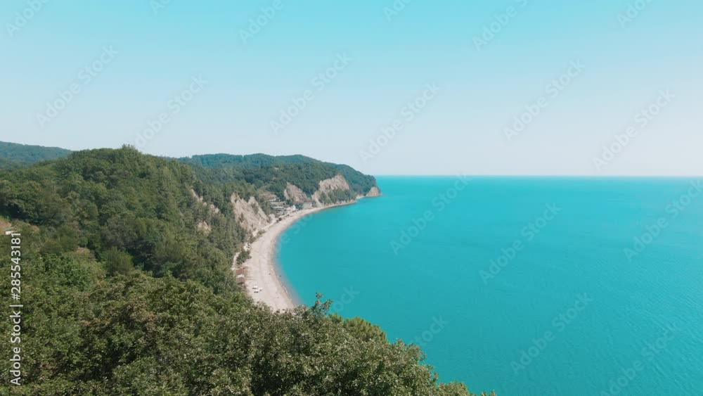 Aerial 4k view tropical beach with blue-green sea, green mountains of the rainforest. Secluded hidden beach in paradise. Blue sky, turquoise calm ocean waves of water. Aerial 4k view tropical beach with blue-green sea, green mountains of the rainforest. Secluded hidden beach in paradise. Blue sky, turquoise calm ocean waves of water.