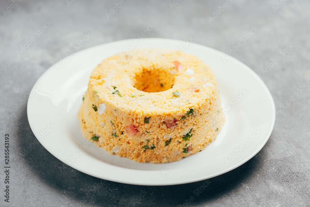 Cuscuz. Traditional Brazilian food prepared from corn flour Stock Photo