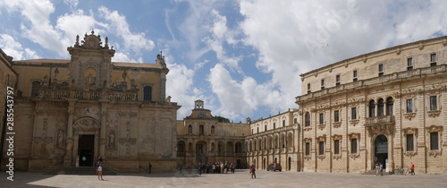Lecce – Piazza Duomo. It includes : double facade Cathedral dedicated to the Assumption of the Virgin ; Bell Tower ; Seminary with baroque facade ; Bishop monumental palace surmounted by a clock.