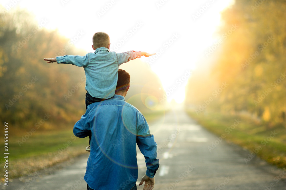 father and son walk in nature - obrazy, fototapety, plakaty 