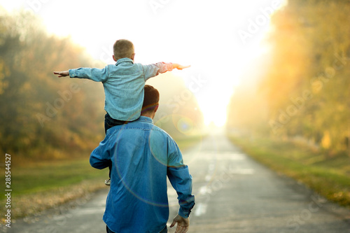 father and son walk in nature photo