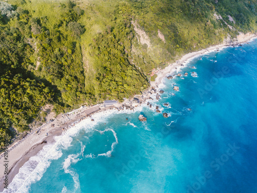 BLUE OCEAN WATERS FLOW INTO SHORE photo