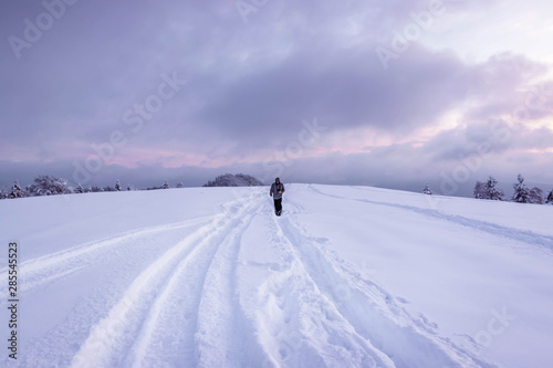 lone figure walks through snow photo