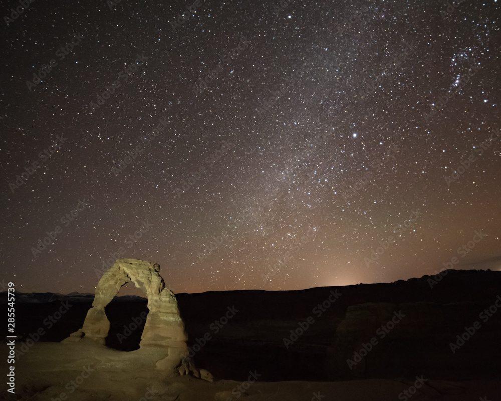 USA, Utah, Grand County, Arches National Park, Klondike Bluffs. A night sky view of the Milky Way above Delicate Arch