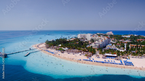 Tourists enjoying themselves at a beach on a clear sunny day. photo