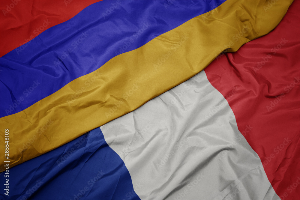 waving colorful flag of france and national flag of armenia.