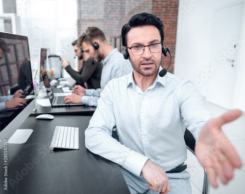 modern businessman in a headset reaching out for a handshake