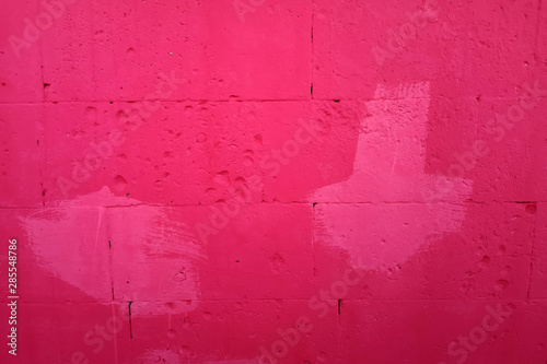 Red concrete wall background with white blurred spots. Beautiful texture. Text insertionConcrete wall background with red