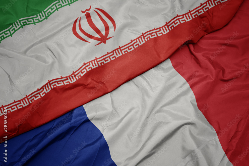 waving colorful flag of france and national flag of iran.