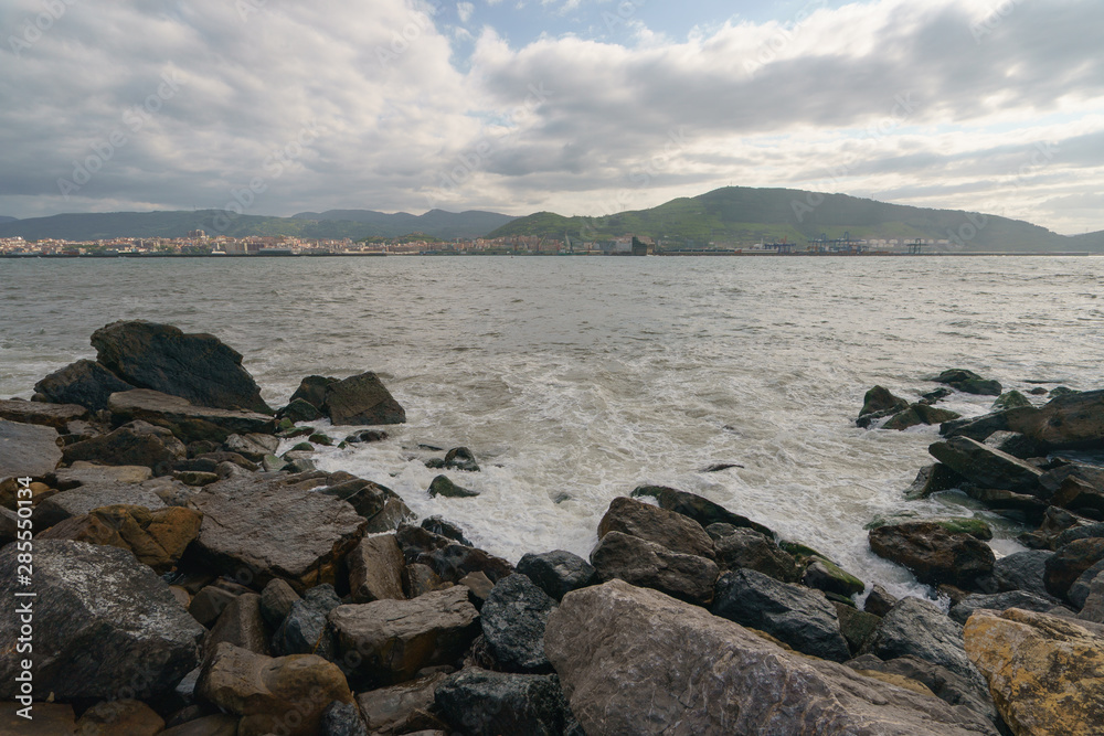 Atlantic ocean, town on the shore of Biscay Bay in summer day in Basque country near Bilbao city. Natural background, suitable for banner, postcard, greeting card, poster. High resolution photography. Atlantic ocean, town on the shore of Biscay Bay in summer day in Basque country near Bilbao city. Natural background, suitable for banner, postcard, greeting card, poster. High resolution photography.