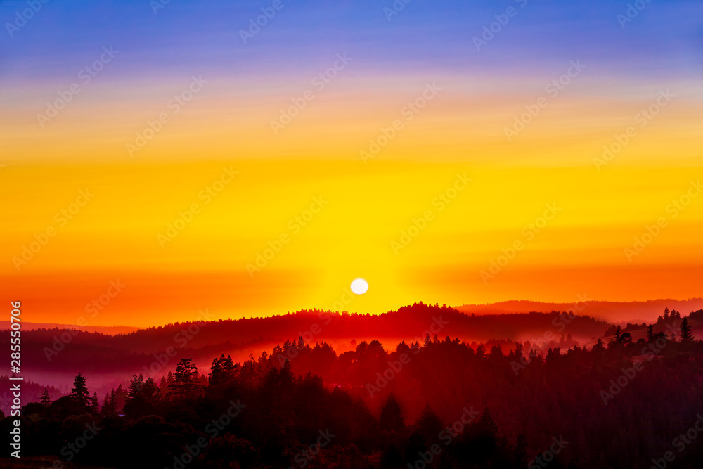 Fototapeta premium Layers of Silhouetted Hills, Forests, Trees, at Sunset