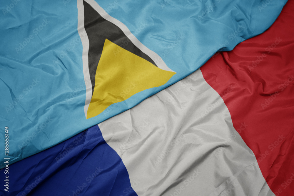Fototapeta premium waving colorful flag of france and national flag of saint lucia.