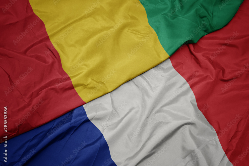 Fototapeta premium waving colorful flag of france and national flag of guinea.