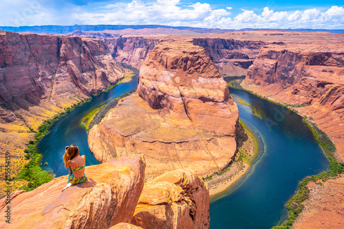 Young tourist girl with green dress in Horseshoe Bend, Arizona. United States