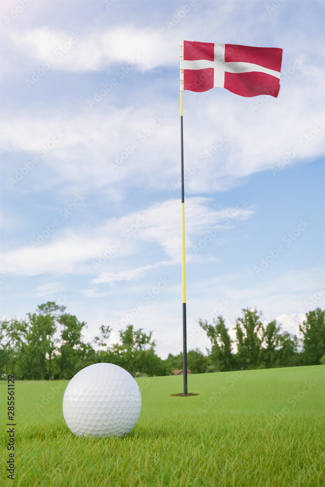 Obraz premium Denmark flag on golf course putting green with a ball near the hole