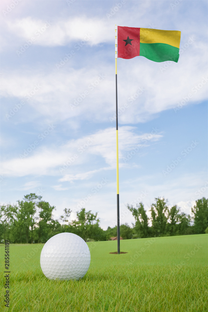Obraz premium Guinea-Bissau flag on golf course putting green with a ball near the hole