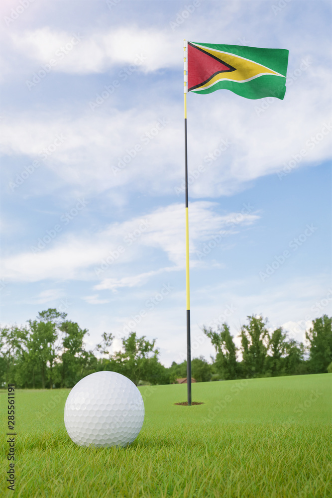 Obraz premium Guyana flag on golf course putting green with a ball near the hole