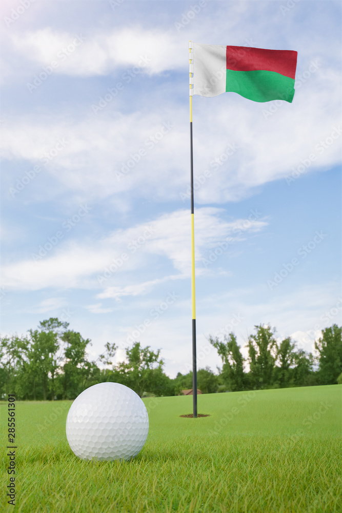 Obraz premium Madagascar flag on golf course putting green with a ball near the hole