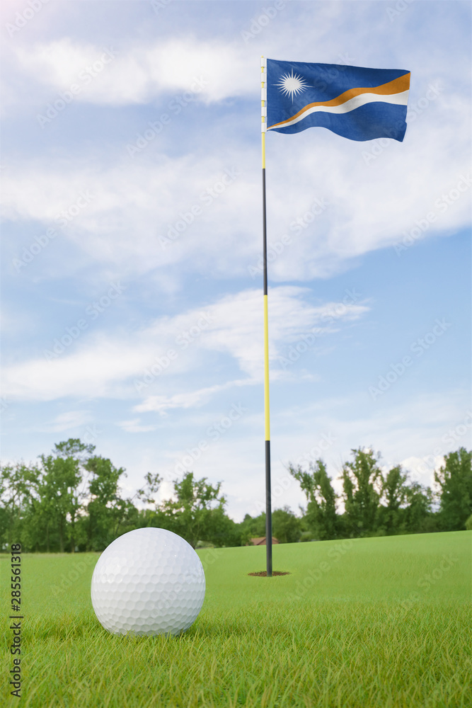 Obraz premium Marshall Islands flag on golf course putting green with a ball near the hole