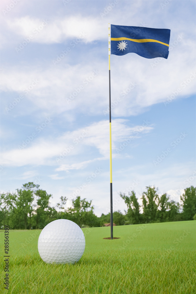 Obraz premium Nauru flag on golf course putting green with a ball near the hole