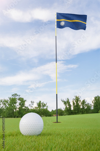 Nauru flag on golf course putting green with a ball near the hole