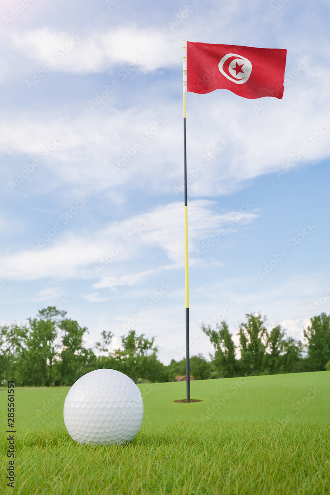 Obraz premium Tunisia flag on golf course putting green with a ball near the hole