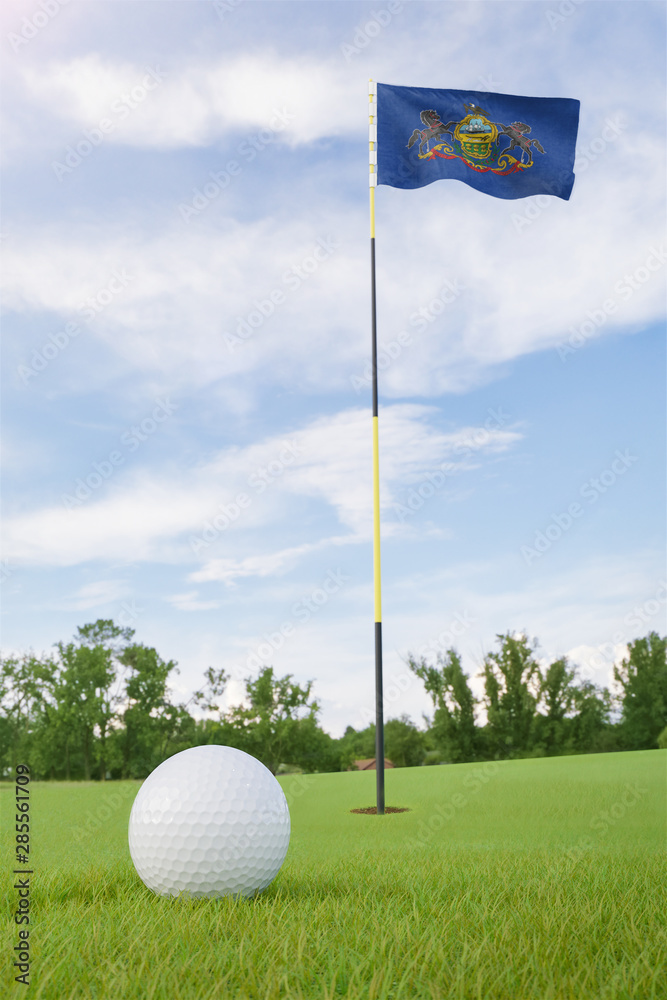 Obraz premium Pennsylvania flag on golf course putting green with a ball near the hole