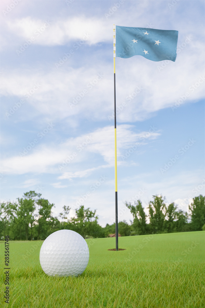 Obraz premium Micronesia flag on golf course putting green with a ball near the hole