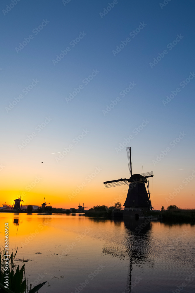 Beautiful Romantic Dutch Windmills in Front of The River in Kinderdijk Village in the Netherlands. Picture Taken At Golden Hour.