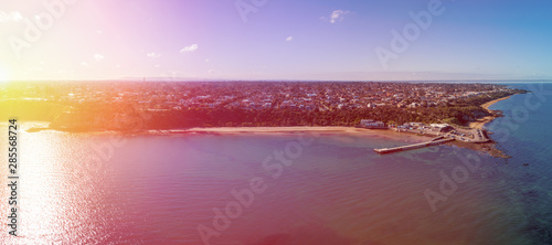 Wide aerial panorama of sunrise over Half Moon Beach and Black Rock wharf in Melbourne, Australia © Greg Brave