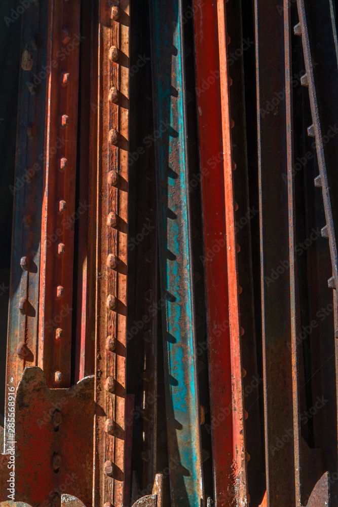 colorful steel fence posts stacked vertically