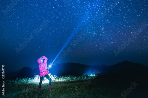 Blue dark night sky with star Milky way Space background and silhouette of a standing happy man
