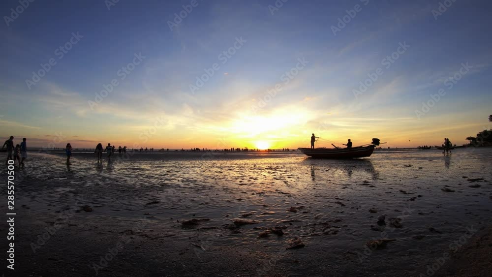 Timelapse / Hyperlapse of a beautiful sunset seen from the beach with a traffic of people and natives of the region arranging the fishing net from inside a boat. Timelapse / Hyperlapse of a beautiful sunset seen from the beach with a traffic of people and natives of the region arranging the fishing net from inside a boat.